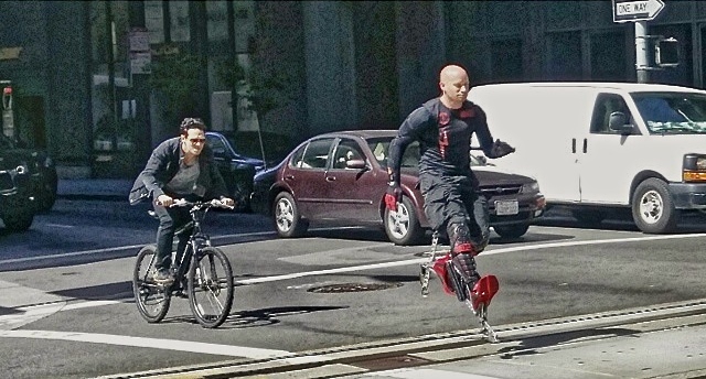 BIONIC BOOTS BEAT CARS AND BIKES THROUGH SF TRAFFIC.